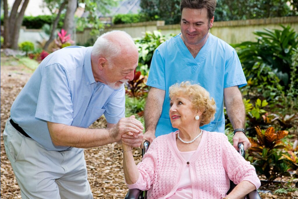 patient with loved one and a nurse at a nursing home facility